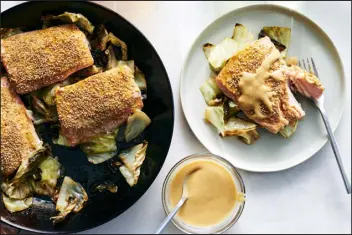  ?? DAVID MALOSH — THE NEW YORK TIMES ?? Ali Slagle’s recipe combines mustard and miso to make a salty, spicy glaze for meaty salmon fillets and tender cabbage — all made in one skillet.