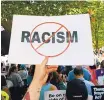  ?? JACQUELYN MARTIN/ASSOCIATED PRESS ?? A man holds up an anti-racism sign at a rally in favor of gun laws held near the White House in Washington on Aug. 6.