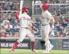  ?? MANUEL BALCE CENETA — AP ?? Philadelph­ia’s Bryce Harper, left, celebrates his eighth-inning home run with teammate J.T. Realmuto in Tuesday’s game against Washington.