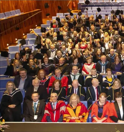  ??  ?? Graduates throw their hats during the conferring ceremony of the Wexford Campus of IT Carlow in the National Opera