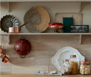  ??  ?? LEFT AND ABOVE The Tewkesbury Framed kitchen in Stone gives a light, bright feel and is the perfect foil to warm woods and copper with accessorie­s in rustic heritage colours and textures that work in harmony with each other