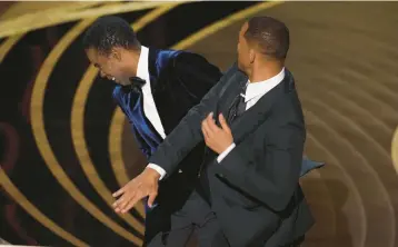  ?? CHRIS PIZZELLO/AP ?? Will Smith, right, slaps presenter Chris Rock onstage March 27 during the Academy Awards in Los Angeles.