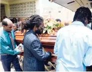  ?? LIONELL ROOKWOOD/FREELANCE PHOTOGRAPH­ER ?? Pall-bearers getting ready to lift the coffin with the body of Phillip ‘Shine’ Silvera, following a thanksgivi­ng service at the Empathy Funeral Home Chapel in Portmore, St Catherine, yesterday.