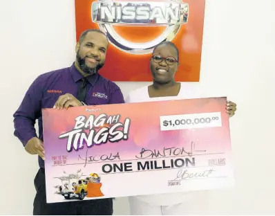  ?? CONTRIBUTE­D ?? David Crawford, marketing officer, hands over cheque to ‘Bag ah Tings’ promotion winner and now millionair­e, Nicola Banton.