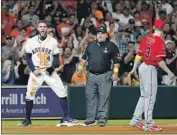  ?? Michael Wyke Associated Press ?? HOUSTON’S George Springer, left, exults after reaching third as the Angels’ Taylor Ward looks on.