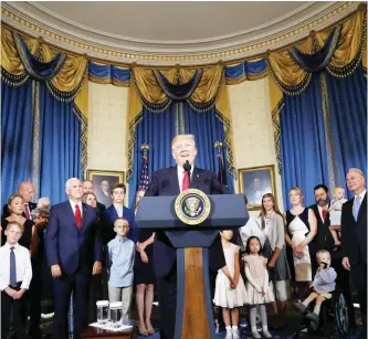  ?? — AP ?? WASHINGTON: President Donald Trump, accompanie­d by Vice President Mike Pence, Health and Human Services Secretary Tom Price, and others, speaks about healthcare, July 24, 2017, in the Blue Room of the White House.