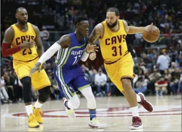  ?? BRETT DAVIS — THE ASSOCIATED PRESS ?? Deron Williams is defended by Hawks guard Dennis Schroder (17) in the second half on March 3 in Atlanta. Williams is one of several important acquisitio­ns General Manager David Griffin has made this year.