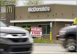  ?? KEITH SRAKOCIC — THE ASSOCIATED PRESS ?? A hiring sign offers a $500 bonus outside a McDonalds restaurant in Cranberry Township, Butler County, Pa., on Wednesday.