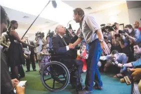  ?? ( MARIE D. DE JESUS/ HOUSTON CHRONICLE VIA AP ?? Texas Gov. Greg Abbott shakes hands with a man arriving at Arcadia First Baptist Church in Santa Fe, Texas, on Sunday.