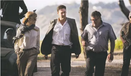  ??  ?? Mad man: Jon Hamm, center, stars with Rosamund Pike and Dean Norris in Beirut, at Violet Crown