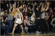  ?? MATTHEW PUTNEY — THE ASSOCIATED PRESS ?? Iowa guard Caitlin Clark, front left, reacts after breaking the NCAA women’s career scoring record during the first quarter against Michigan on Thursday in Iowa City, Iowa.
