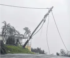  ?? DANGER: Powerlines down at Airlie Beach. Picture: ALIX SWEENEY ??