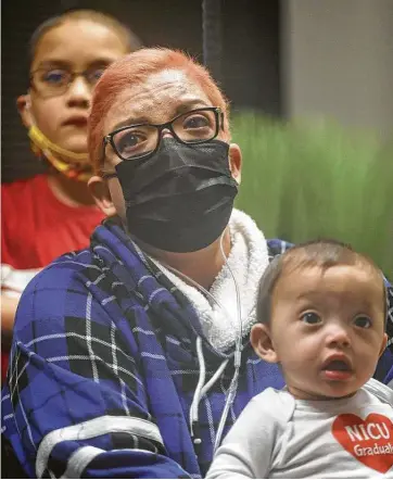  ?? Photos by Jon Shapley / Staff photograph­er ?? Crystal Gutierrez holds her son Matthew, 7 months, as she meets her former medical caregivers who helped her battle COVID-19 on Friday, Feb. 12, 2021, at Houston Heart in Houston.