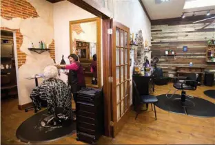  ?? Star-Telegram via AP ?? Linda Garcia styles the hair of Betty Sue Kedy at Studio 2020, a salon that was once the Mosier Valley Schoolhous­e, where children of former slaves were taught until the late 1960s. Mosier Valley, tucked between Fort Worth, Euless and Arlington, was...
