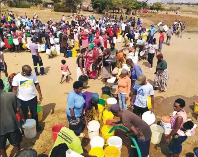  ??  ?? Sizinda Flats residents jostle to get water donated by the Bulawayo Water Action group on Saturday