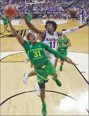  ?? Associated Press ?? Blocked from the back: Oregon guard Dylan Ennis (31) drives to the basket ahead of Kansas guard Josh Jackson (11) during the second half of the Midwest Regional final Saturday in Kansas City, Mo.