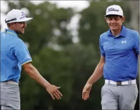  ?? GERALD HERBERT — THE ASSOCIATED PRESS ?? Jonas Blixt congratula­tes teammate Cameron Smith after they birdied the 18th hole during the third round of the PGA Zurich Classic on Saturday.