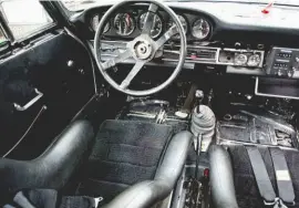  ??  ?? Below left: Although stripped of carpets and sound deadening, the interior remained remarkably stock in appearance