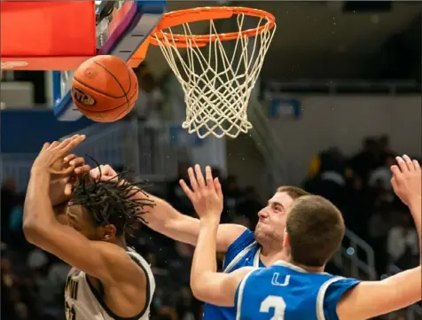  ?? Lucy Schaly/Post-Gazette ?? Union’s Matt Stanley, right rear, fouls Imani Christian’s Bez Abdul in the WPIAL Class 1A championsh­ip Thursday at Petersen Events Center. Imani defeated Union, 64-41.