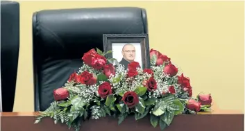 ?? DAVE JOHNSON/WELLAND TRIBUNE ?? Flowers and a photo of Ward 5 Coun. Rocky Letourneau sit at his space in Welland city council chambers. At Tuesday’s council meeting, Mayor Frank Campion paid tribute to Letourneau, who died June 22.