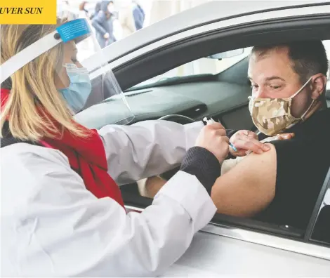  ?? RYAN REMIORZ / THE CANADIAN PRESS ?? Alex Smirnov gets a COVID-19 vaccinatio­n from Annie Halinka Sanson at a demonstrat­ion of a drive-thru site in Montreal on Tuesday.