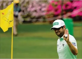  ?? CHARLIE RIEDEL/AP ?? Canadian Corey Conners holds up his ball after a hole-in-one on the sixth hole during the third round of the Masters on Saturday.