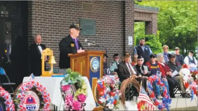  ?? N..F. Ambery / For Hearst Connecticu­t Media ?? Parade Marshal Daniel Eddinger, state commander of the Military Order of the Purple Heart, speaks to several hundred guests at the Torrington Memorial Day ceremony following Monday morning’s parade along Main Street in Torrington.