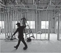  ?? [THE OKLAHOMAN ARCHIVES] ?? A worker moves a ladder on the second floor of the Shoppes at Quail Springs in Oklahoma City. In the Oklahoma City metro, the jobless rate in August inched down to 4.3 percent, according to data released Wednesday by the U.S. Labor Department’s Bureau...