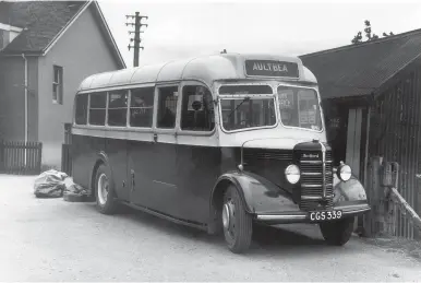  ?? Graham Martin-Bates Collection ?? This Bedford OB with Mulliner B25FM body (a 25 seat front entrance bus with mail compartmen­t) was in the Achnasheen Hotel Co fleet from July 1949 until withdrawn in September 1960. In early BR (Scottish Region) timetables there is a ‘Motors’ section for connecting buses, the summer 1949 issue noting two at Achnasheen. The main service was LaideAultb­ea-Poolewe-Gairloch-Loch MareeKinlo­chewe-Achnasheen – departing at 9am and arriving at 11.45am, with return at 1pm (times for June onwards), the distance being 43 miles. The other service was the 9.55am from Torridon, south of Kinlochewe, this bus being at Achnasheen between 11.05am and 1pm, before returning, so both buses met the mid-morning trains from Inverness and Kyle of Lochalsh. By 1955 the bus times were no longer in the timetable. With mail bags at the rear, CCS 339, most likely in a scarlet and primrose livery, is parked by the main Achnasheen station building, which is hard up against the hotel. The corrugated metal building is Achnasheen Post Office.