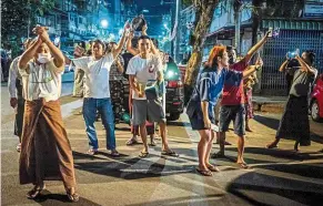  ??  ?? Loud and proud: People taking part in a noise campaign on the street after calls for protest went out on social media in Yangon. — AFP