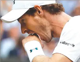  ?? Associated Press photos ?? Britain's Andy Murray reacts as he loses a point to Sam Querrey of the United States during their men's singles quarter-final match on day nine at the Wimbledon Tennis Championsh­ips in London Wednesday.