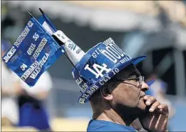  ?? Robert Gauthier Los Angeles Times ?? DUDLEY STEWART III, wearing a hat honoring Dodgers players from the past, watches pregame activities before the team’s home opener against the Giants.