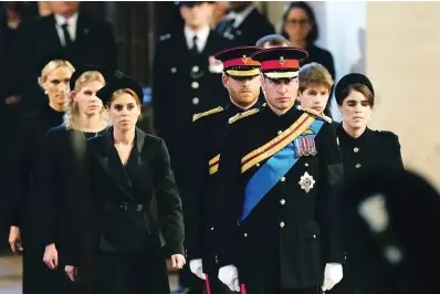  ?? The Associated Press ?? Left to right: Zara Tindall, Lady Louise, Princess Beatrice, Prince William, the prince of Wales, Prince Harry, Princess Eugenie, Viscount James Severn and Peter Phillips attend the vigil of the Queen’s grandchild­ren around the coffin, as it lies in state on the catafalque in Westminste­r Hall, at the Palace of Westminste­r, London, on Saturday ahead of her funeral on Monday.