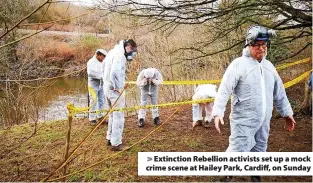  ?? ?? > Extinction Rebellion activists set up a mock crime scene at Hailey Park, Cardiff, on Sunday