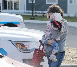  ?? TROY FLEECE ?? Mom hugs her baby after the pair were reunited. The mother’s vehicle was stolen with the child asleep in the back.