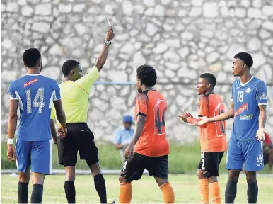 ?? RICARDO MAKYN/MULTIMEDIA PHOTO EDITOR ?? Referee Tyrone Robinson shows a red card to Portmore United’s Romaine Brackenrid­ge (right) during a recent Red Stripe Premier League encounter between Portmore and Tivoli Gardens at the Spanish Town Prison Oval.