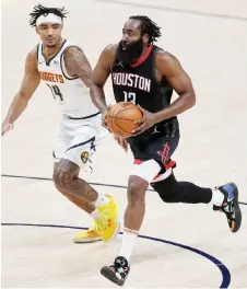  ?? — AFP photo ?? James Harden of the Houston Rockets drives to the basket against Gary Harris of the Denver Nuggets in the third quarter at Ball Arena in Denver, Colorado. The Nuggets won 124-111.