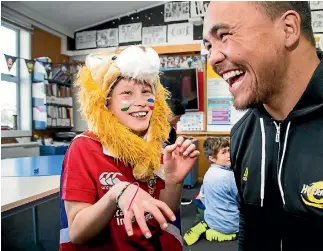  ?? PHOTO: MAARTEN HOLL/FAIRFAX NZ ?? Brooklyn Primary School student Florence Le Masurier, 10, shares a laugh with Hurricanes prop Mike Kainga at the school on Monday during a match of coin rugby.