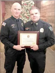  ?? COURTESY PHOTO ?? Cpl. David Faulk with Prairie Grove Police Department, left, was awarded the Certificat­e for Merit for his hard work, dedication and accomplish­ments during the year 2016. Chief Chris Workman presented the award to Faulk.