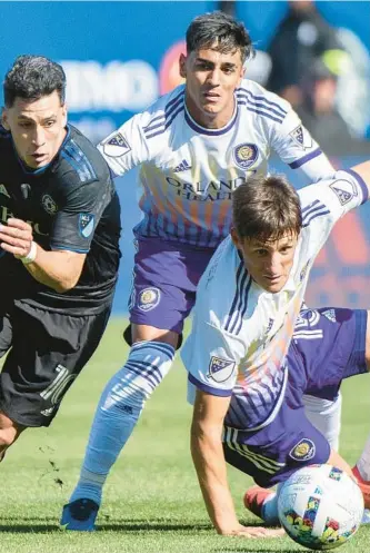  ?? MLS GRAHAM HUGHES/AP ?? CF Montreal’s Joaquin Torres, left, breaks away from Orlando City’s Rodrigo Schlegel, who has filled in at centerback after an injury to Antonio Carlos, in a May 7 meeting.