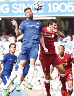  ?? — AFP photo ?? Olivier Giroud (left) scores the opening goal during the English Premier League match between Chelsea and Liverpool at Stamford Bridge in London.