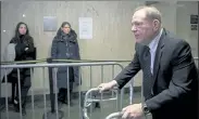  ?? MARY ALTAFFER / AP ?? Women watch Harvey Weinstein leave the courtroom Wednesday at the end of the first day of his trial in New York on rape and sexual assault charges.