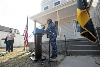  ??  ?? Diamonte Walker, deputy executive director of the city Urban Redevelopm­ent Authority, explains OwnPGH — an affordable homeowners­hip and neighborho­od blight-fighting initiative — in early March in front of a newly rehabilita­ted home on Mayflower Street in Larimer.