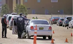  ??  ?? Medics with the Santa Fe Fire Department check on a man who experience­d side effects after receiving a vaccine Friday at the midtown campus. Health officials say there is a silver lining to most side effects — they are a normal sign the body is building protection against COVID-19.