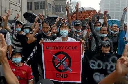  ?? AP ?? Anti-coup protesters flash their three-finger salute during a demonstrat­ion in Yangon yesterday. The United Nations envoy for Myanmar says the military is facing ‘‘unexpected difficulti­es’’ in consolidat­ing power after overthrowi­ng the country’s elected government in February.