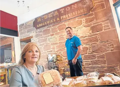  ??  ?? TALKING POINT: Owner Ann MacKinnon with her partner David Shields and the 19th-Century shop sign