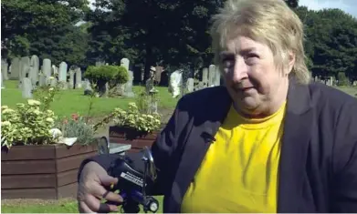  ??  ?? Campaign: Bereaved mother Lydia Reid at Saughton Cemetery in Edinburgh yesterday