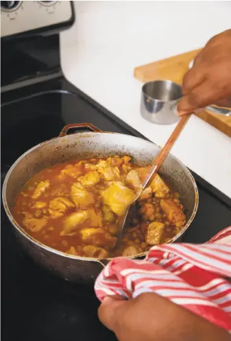  ?? Photos by Dan Liberti ?? Arroz con gandules is a soulful Puerto Rican dish made with sofrito, rice, pork and pigeon peas. The pork is from Spain, and the pigeon peas from Africa.