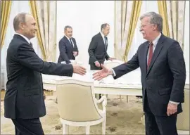  ?? Alexander Zemlianich­enko AFP/Getty Images ?? VLADIMIR Putin greets U.S. national security advisor John Bolton in Moscow.