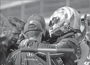  ?? Associated Press ?? Not in the field: James Hinchcliff­e, of Canada, consoles the crew after they did not qualify for the Indianapol­is 500 auto race at Indianapol­is Motor Speedway in Indianapol­is Saturday.